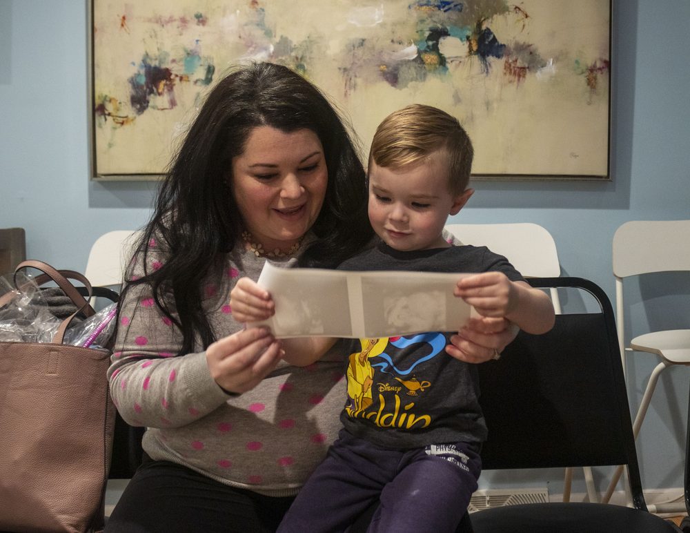 Big sibling reading a new-baby storybook at Wonder Time